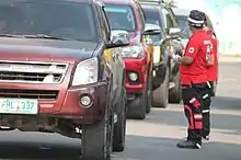 Philippine Red Cross volunteers scanning the temperature of commuters entering the provincial capitol in Bayombong, Nueva Vizcaya