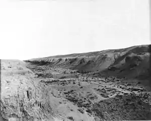 A black and white photo of a dry riverbed