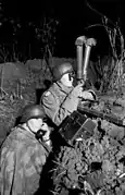 A team of German artillery observers using  periscope binoculars, 1943